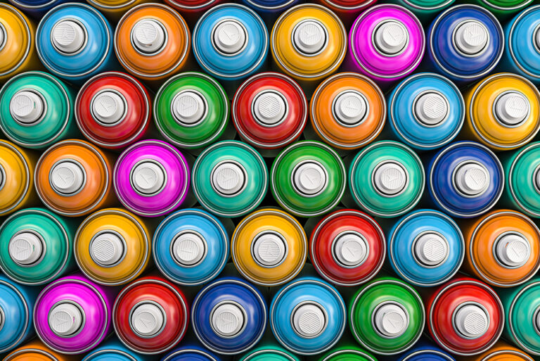 Top view of colorful graffity spray paint cans or bottles of aer